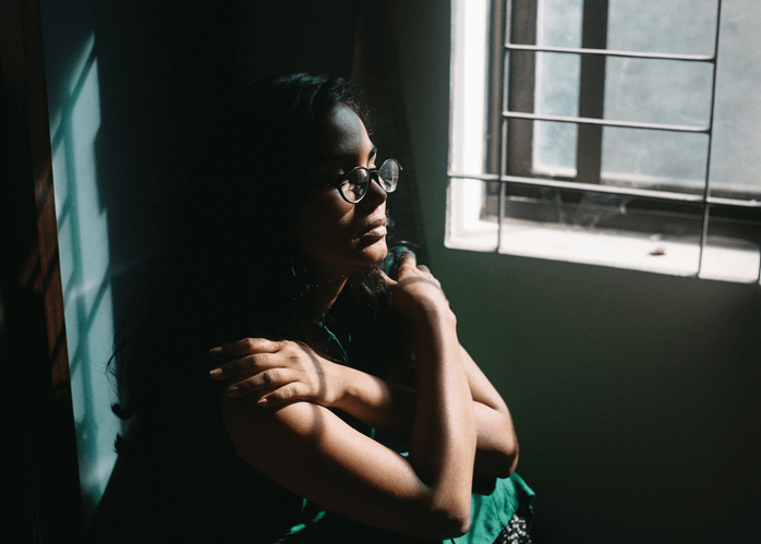 woman looking out window