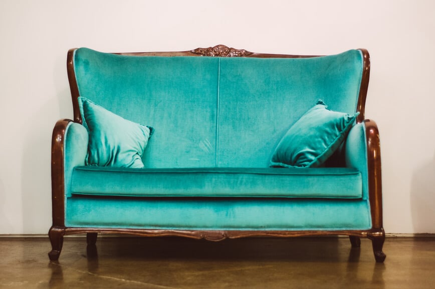 green couch against plain wall
